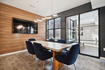 a conference room with a table and chairs and a television at The Anchorage on Kelly, East Falls, 19129